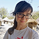 Photo of woman with dark hair wearing glasses