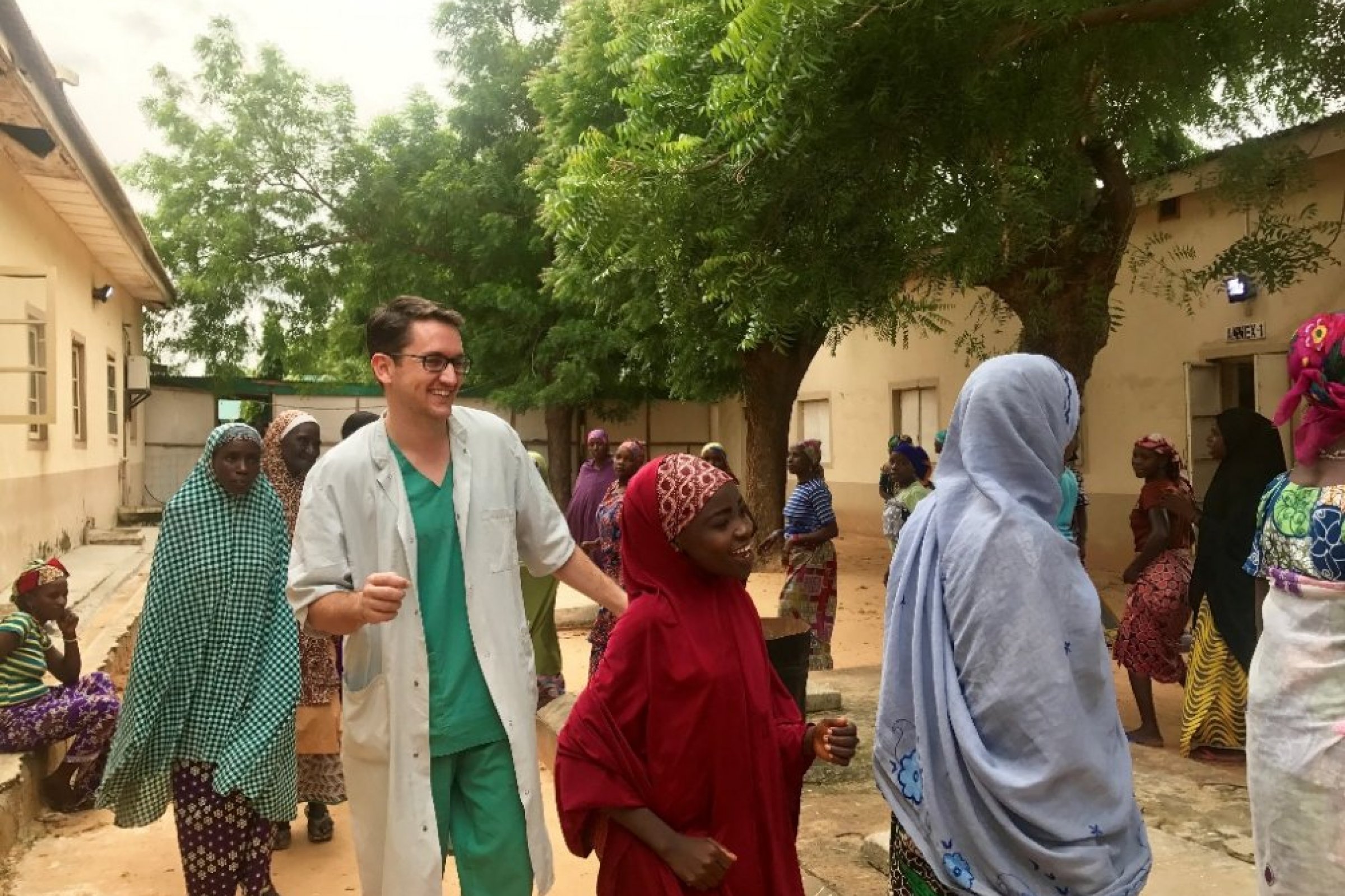 Jared dances with patients outside the fistula ward in Jahun