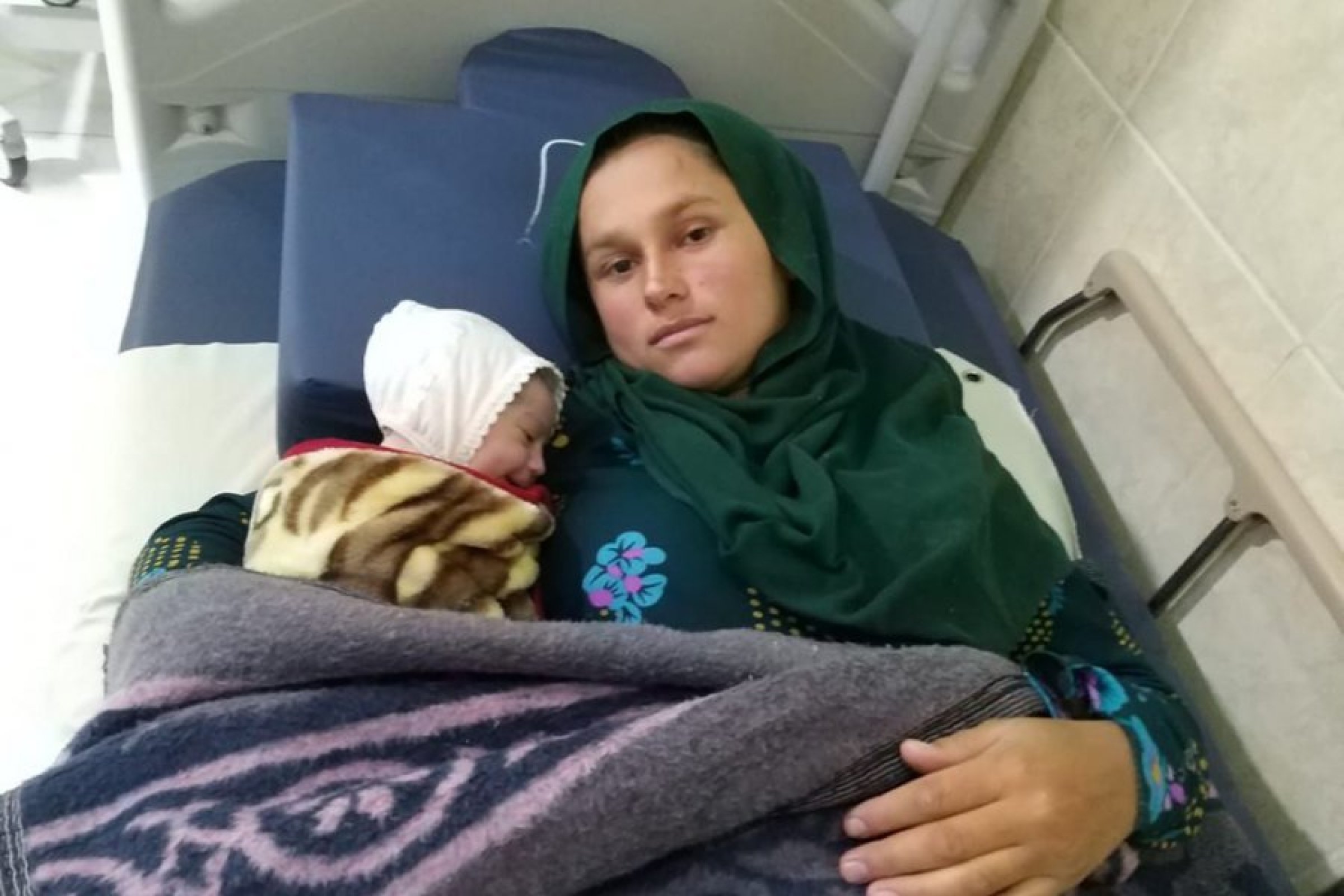 Fatila with her baby in Sinuni, Iraq